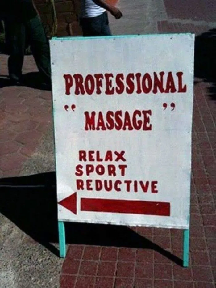 A sidewalk sign with misused quotation marks around the word massage.