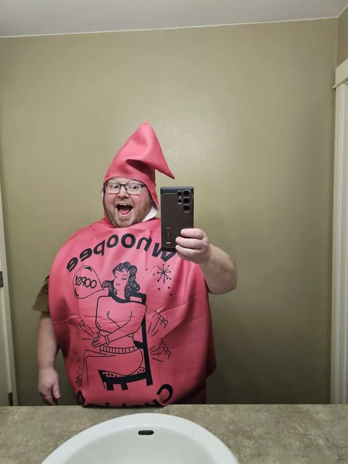 A man wearing a funny whoopee cushion outfit as a low-effort Halloween costume taking a selfie.