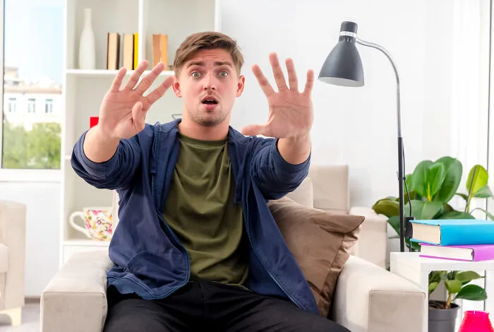 Shocked man gesturing to stop obvious lies