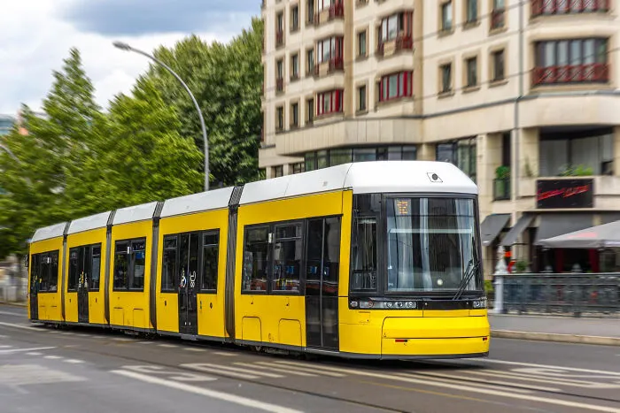 Yellow tram moving fast on city street in intense survival moments