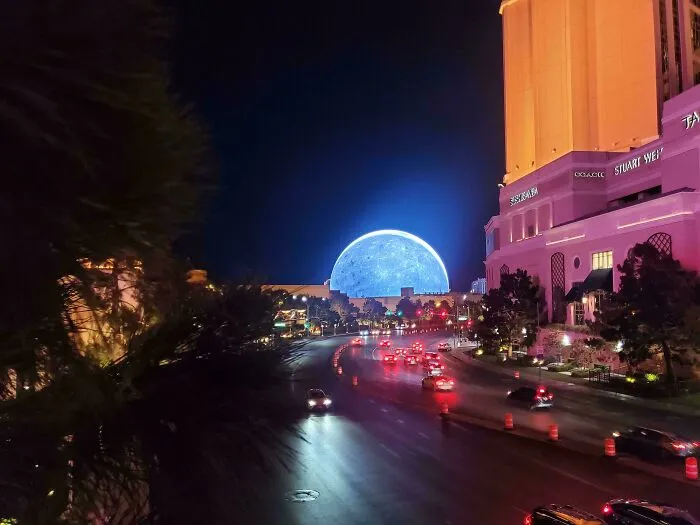 The Sphere in Las Vegas glowing bright blue at night, an example of how buildings turn heads with bizarre shapes