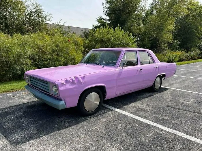A light purple sedan parked in a lot, representing wonderful vehicles with unusual custom paint jobs.