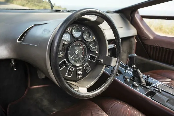 A futuristic dashboard and steering wheel setup inside one of these wonderful vehicles.