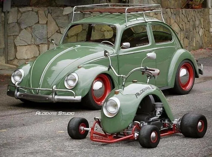 Green classic Volkswagen Beetle alongside a matching custom go-kart, highlighting weird and wonderful vehicles.