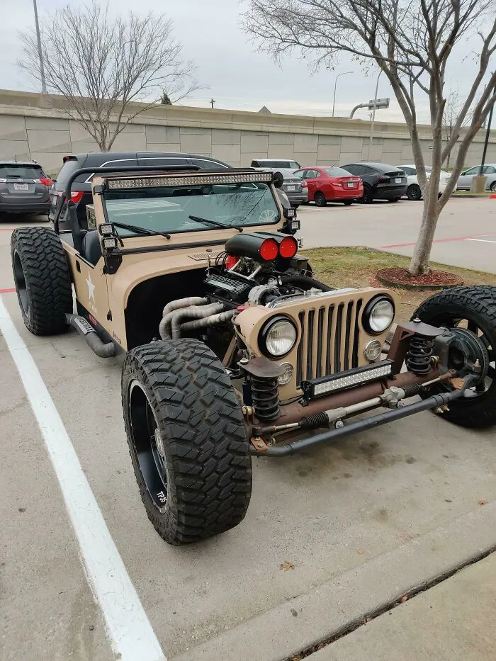 A custom tan hot rod jeep parked outside, an example of wonderful vehicles.