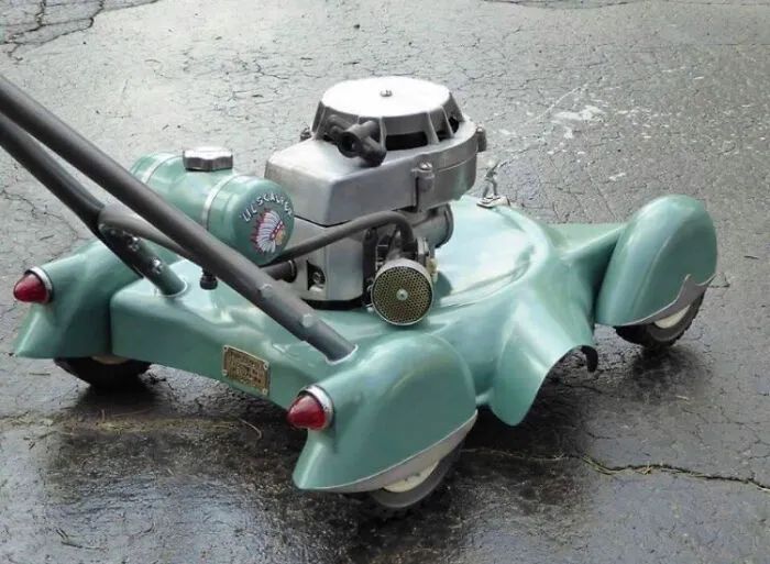 Vintage green lawnmower styled like a custom vehicle.