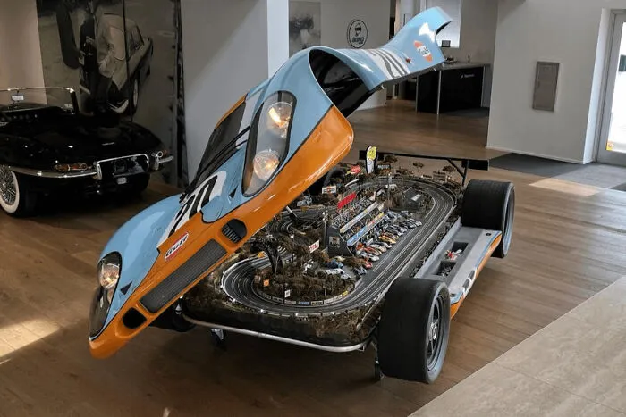 Unique slot car race track built inside a custom race car body.
