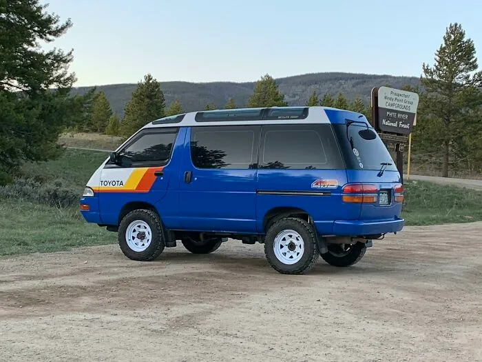 Blue Toyota 4WD camper van parked on a dirt road, an example of wonderful vehicles.