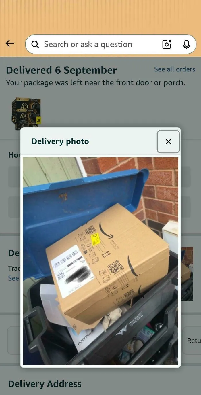 A delivery photo showing an Amazon package left in a trash bin.