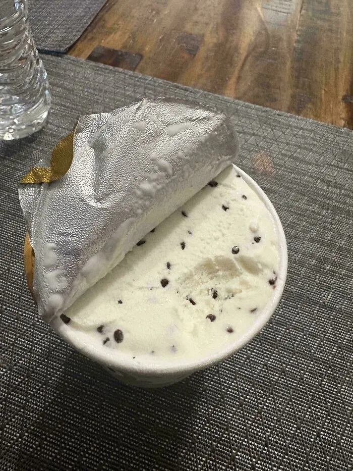 Mint chocolate chip ice cream tub with a bite taken out, showing things went wrong pics of food disappointment.