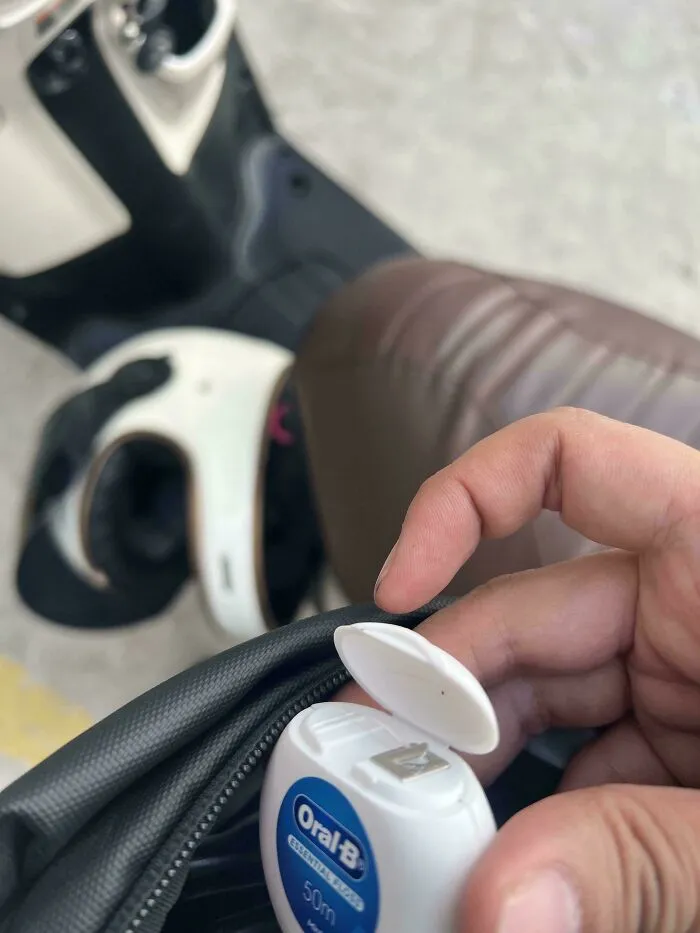 An Oral-B dental floss container missing its thread, demonstrating a moment when things went wrong