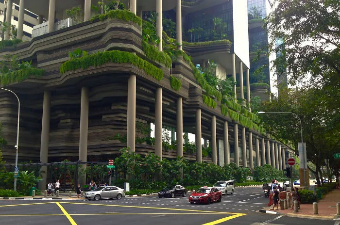 A modern eco-friendly hotel with lush green terraces, demonstrating how buildings turn heads with bizarre shapes