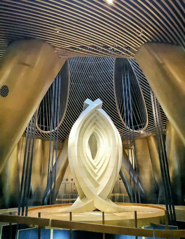 Futuristic interior of a building with bizarre shapes, featuring a glowing abstract centerpiece