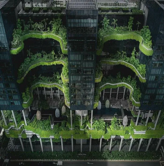 Eco-friendly modern skyscraper featuring lush green terraces and bizarre shapes of architecture