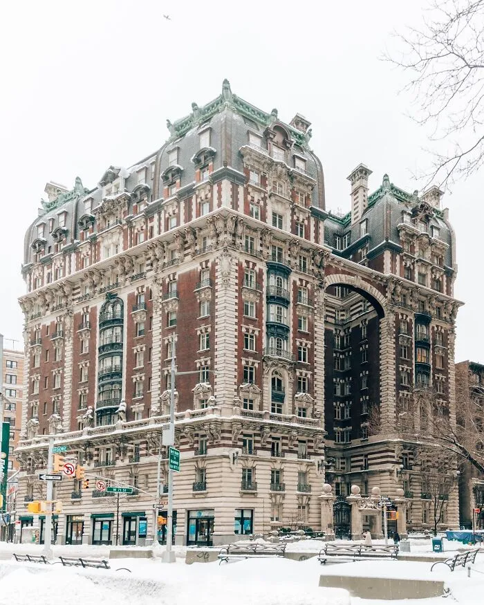 The Ansonia building in NYC featuring ornate classic architecture covered in winter snow
