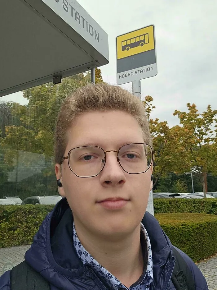 A man wearing wireframe glasses where things went wrong with the misaligned right lens