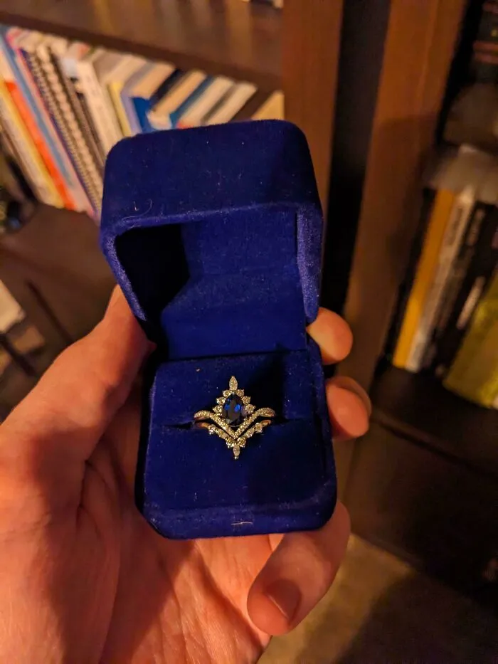 Intricate blue gemstone ring in a velvet box, things went wrong with sizing.