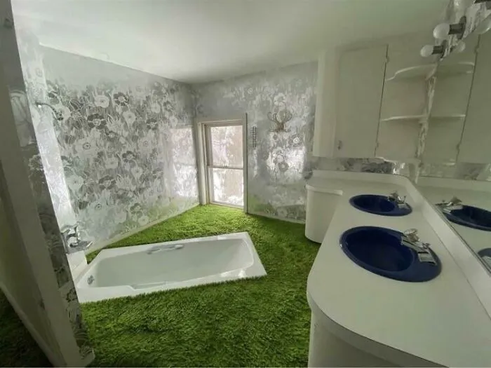 Quirky DIY Projects bathroom featuring a vibrant green shag carpet floor surrounding a built-in white bathtub