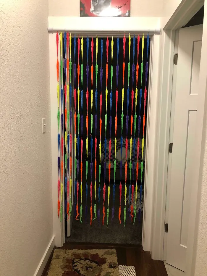 Colorful DIY projects hanging as a doorway curtain made from bright plastic worms