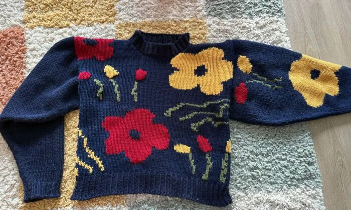 A colorful floral sweater displaying expert knitting techniques