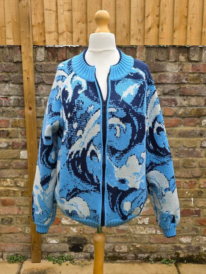 Handmade blue and white ocean wave patterned knitting on a mannequin jacket