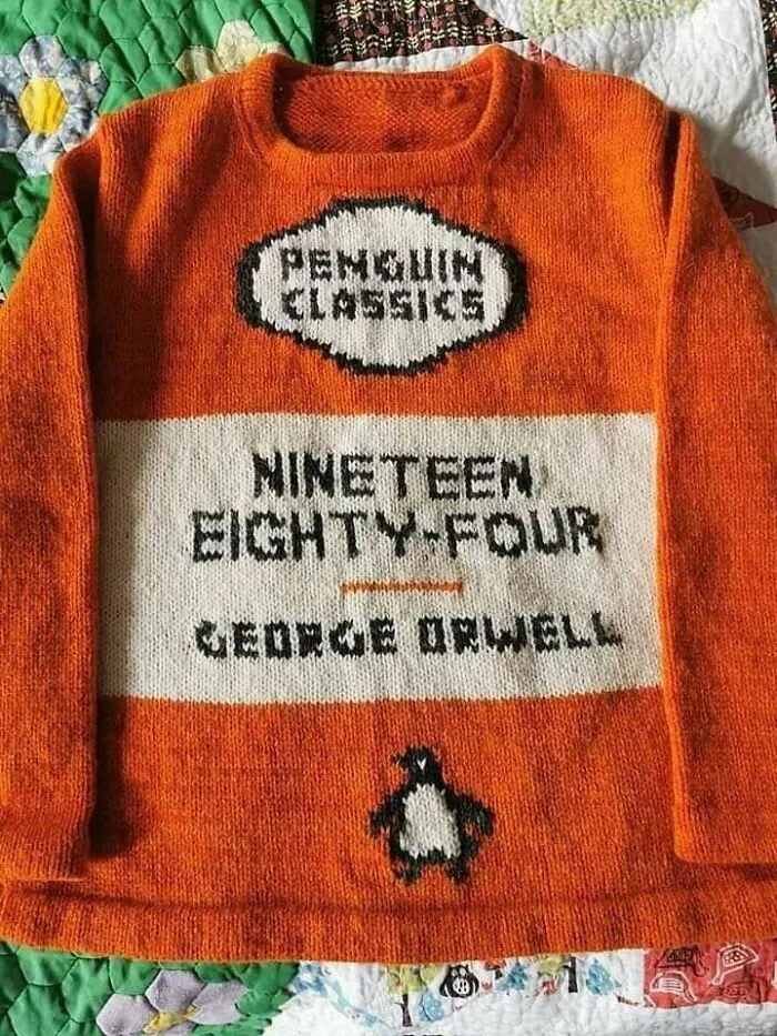 An orange knitted sweater resembling a Penguin Classics book cover, designed by knitting pros