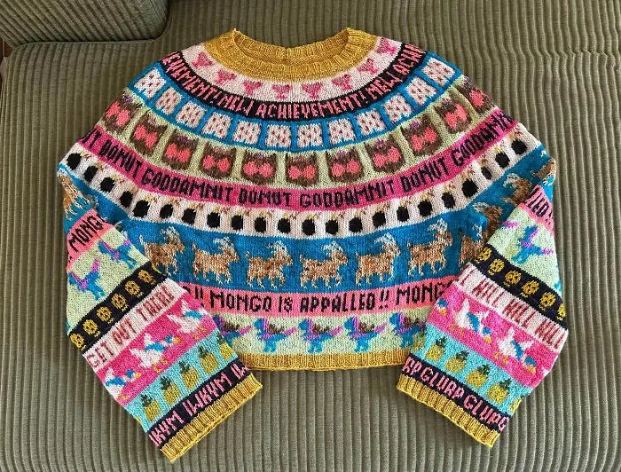 A colorful patterned sweater with text and goats, made by knitting amateurs and pros