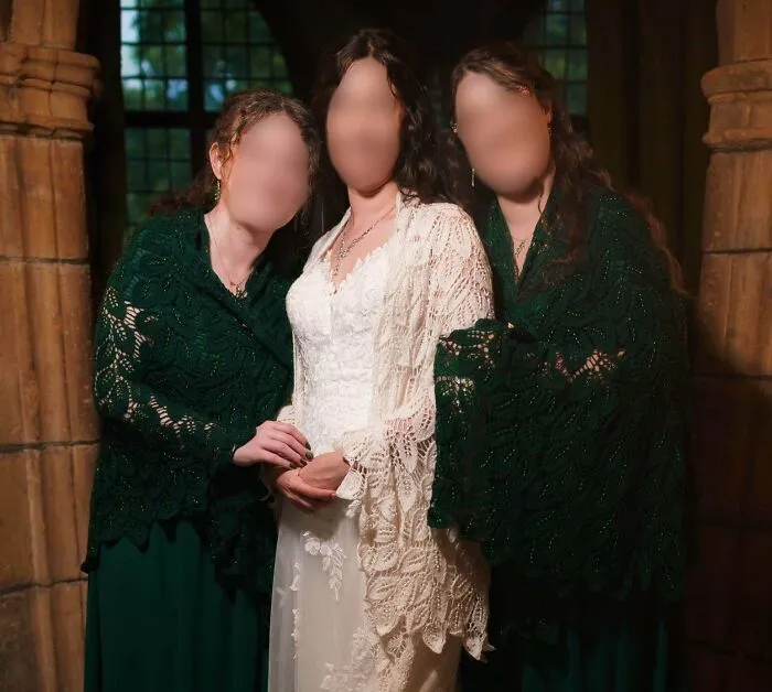 Three women wearing intricate lace shawls, showcasing high-skill knitting projects.