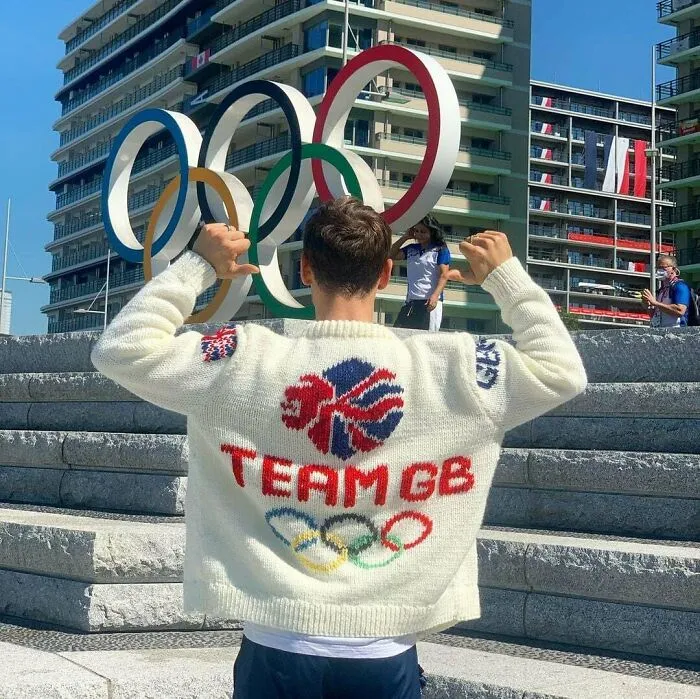 Olympic athlete showing off a custom Team GB knit sweater highlighting top knitting pros