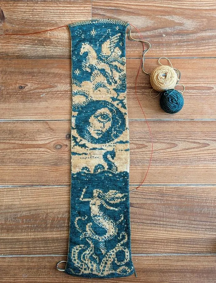 Intricate blue and cream knitting pattern featuring mythical creatures like Pegasus and a mermaid.