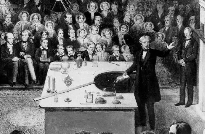 Engraving of Michael Faraday performing a science demonstration, among historical treasures from the past.
