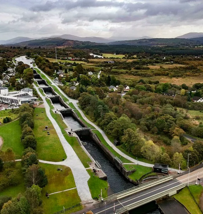 Historical treasures aerial view of a canal lock system running through a lush green landscape.