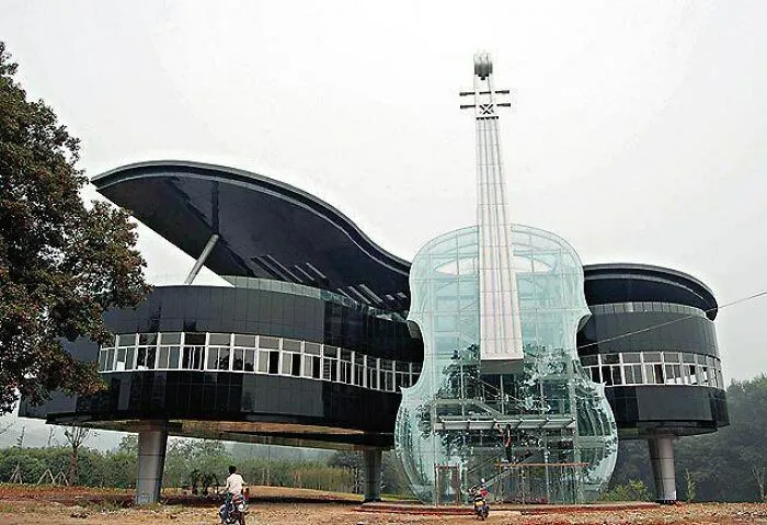 A violin and piano-shaped building showcasing bizarre architecture.