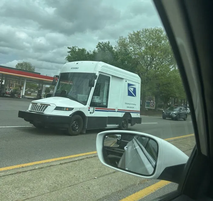 Futuristic USPS mail delivery van driving on the road, an example of wonderful vehicles.