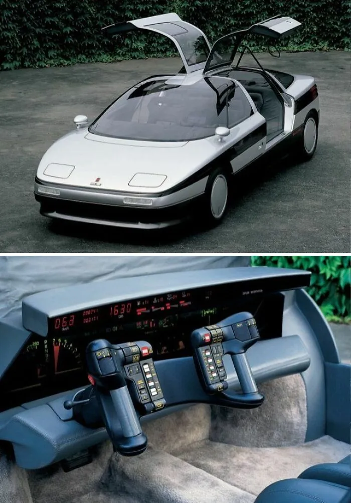 A silver concept car with gullwing doors and futuristic cockpit interior, part of weird and wonderful vehicles.