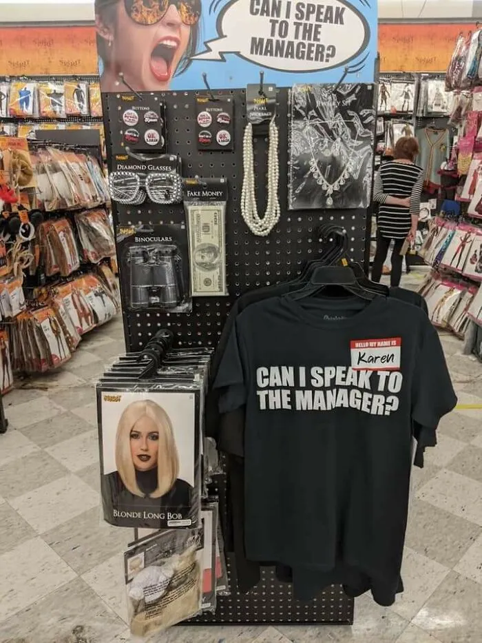 A Halloween costume display mocking Karen behavior with a Can I speak to the manager t-shirt