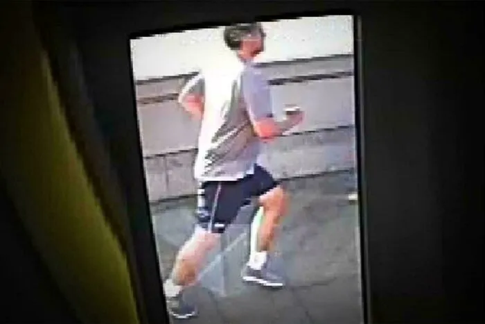 Grainy surveillance camera footage of a man jogging, featured in creepy mysteries from around the web