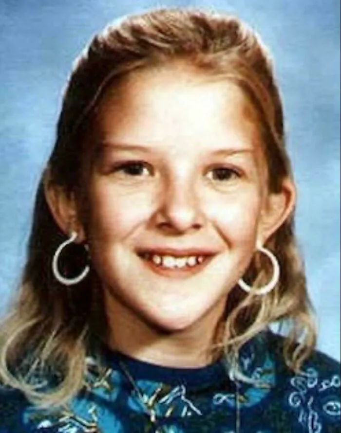 Vintage school portrait of a young girl smiling, featured in creepy mysteries stories.
