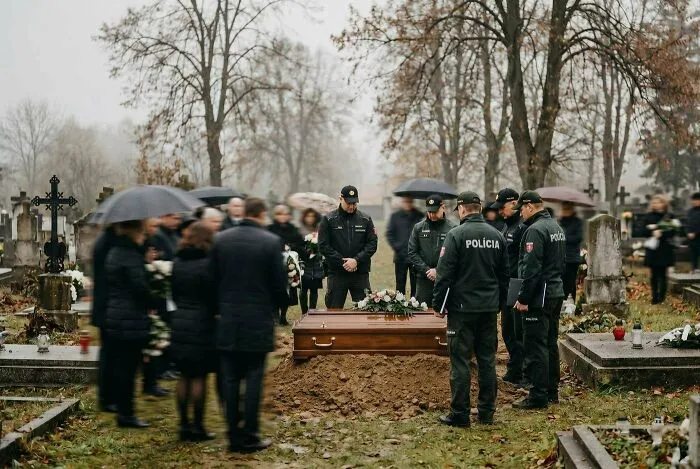 Police officers attending a funeral service around a coffin, part of creepy mysteries discussed online.