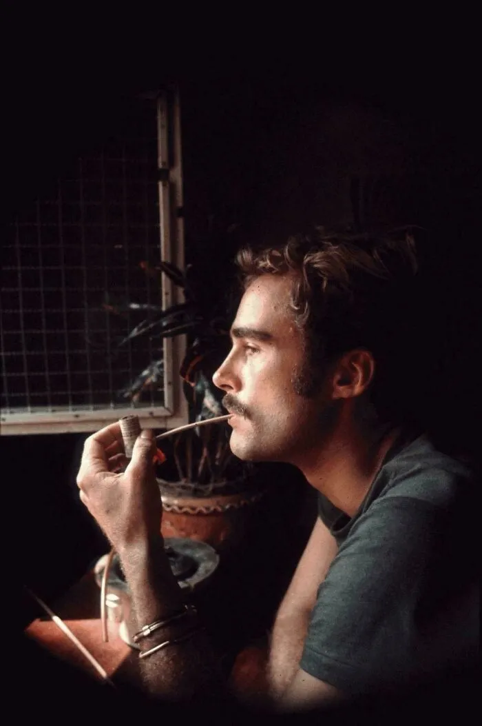 Side profile of a man with a mustache smoking a pipe, tied to creepy mysteries online.