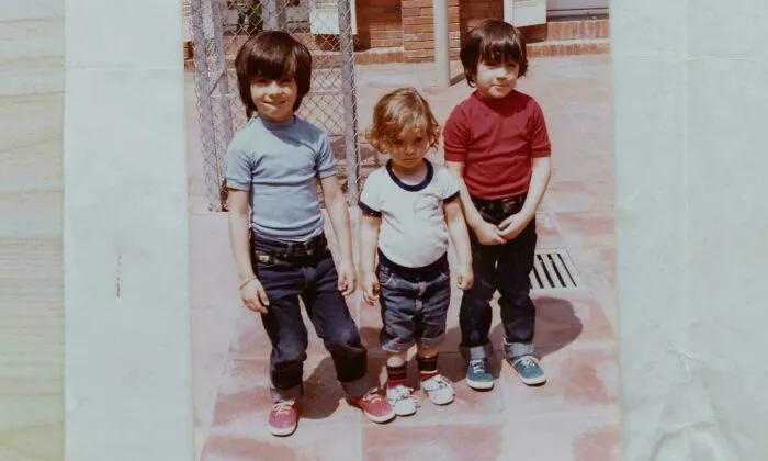 An old photograph showing three young children standing outdoors, connected to creepy mysteries from around the web.
