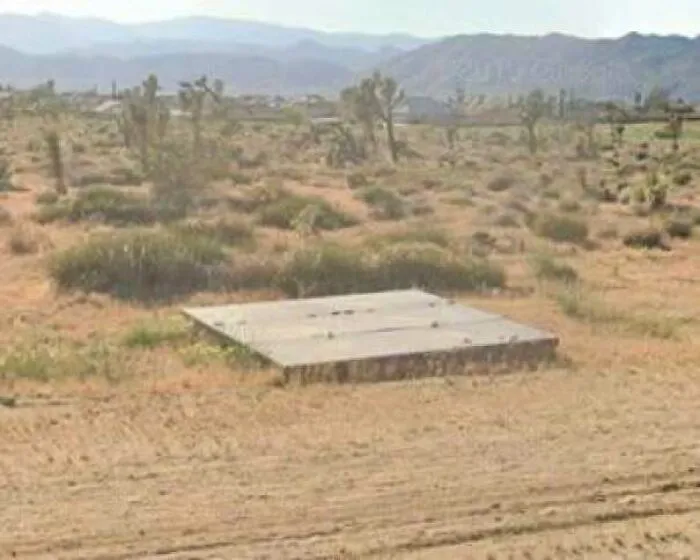 An isolated concrete slab in a desert landscape linked to creepy mysteries online.