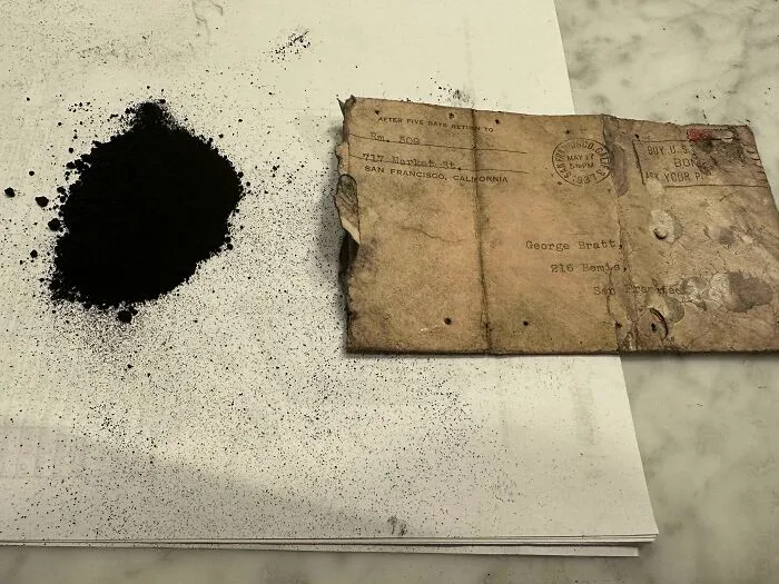 Black powder beside an old vintage envelope linked to web mysteries