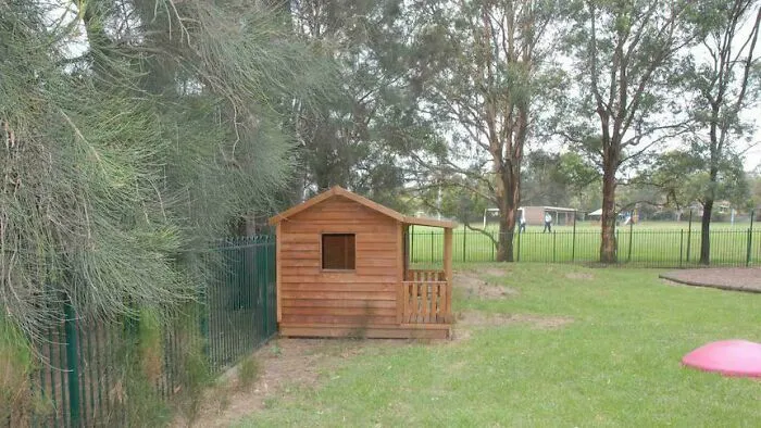 A wooden playhouse in a grassy yard, tied to creepy mysteries.