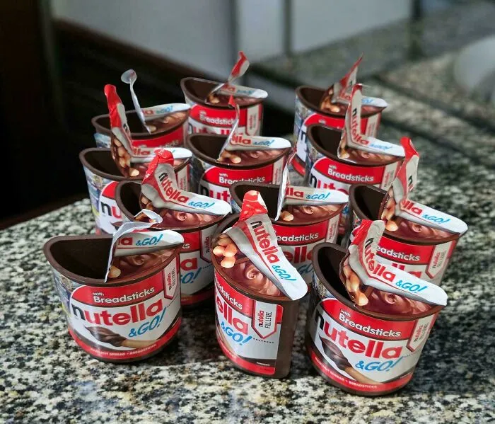 An excessive pile of empty Nutella & GO cups left on a counter, typical of frustrating roommate stories.
