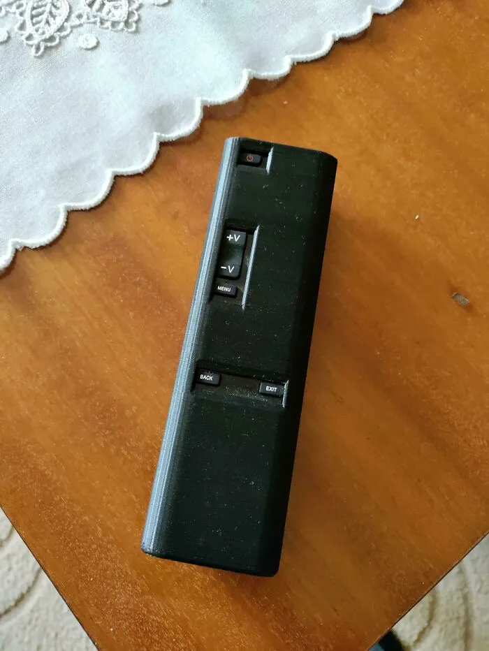 A custom black 3D print TV remote control replacement cover with simplified buttons.