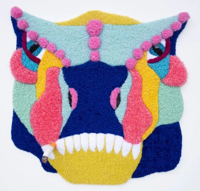 Abstract tufted creature face rug holding a cigarette by Ina Dyreborg