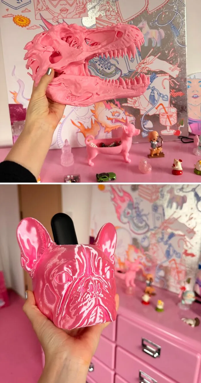 Bright pink dinosaur skull and French bulldog head display pieces from 3D prints