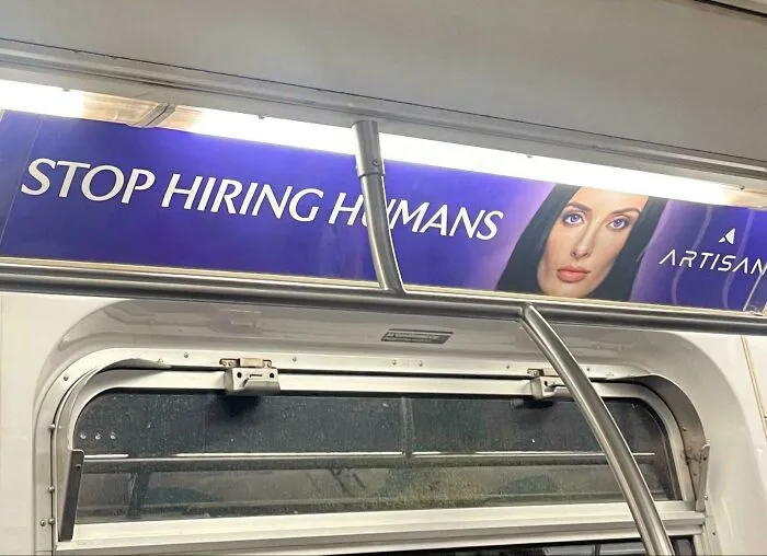 An ominous subway advertisement reading Stop Hiring Humans, showcasing modern life in America with AI.