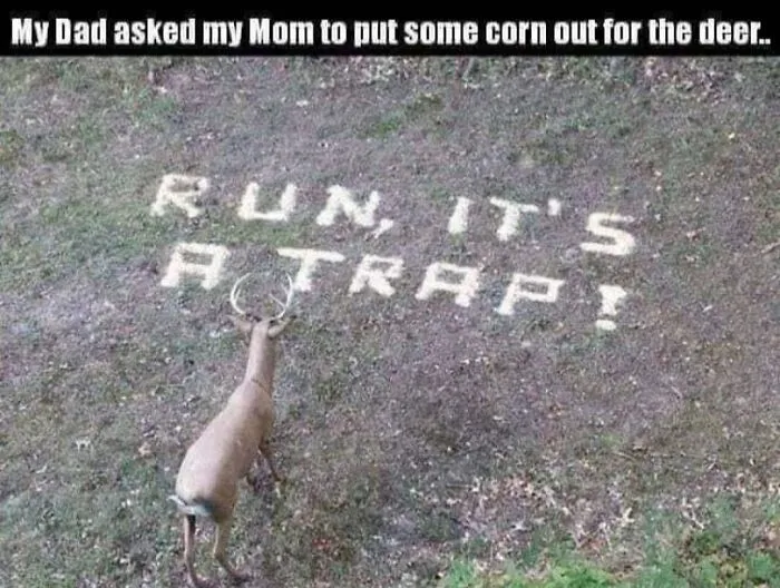 Deer standing near feed spelled out as a warning in a funny redneck meme.